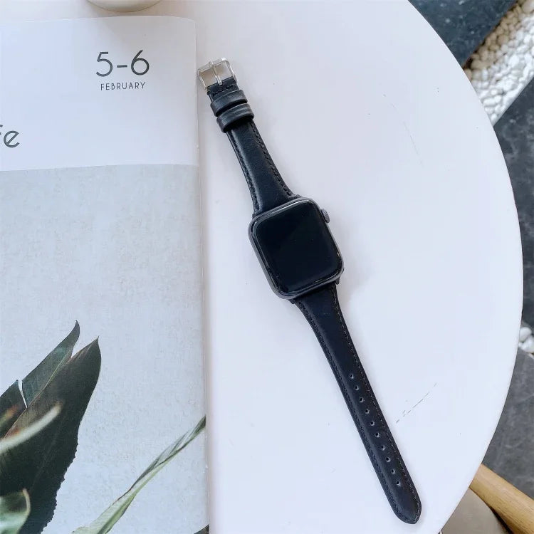 Double-sided genuine leather apple watch band displayed on a table next to a calendar.