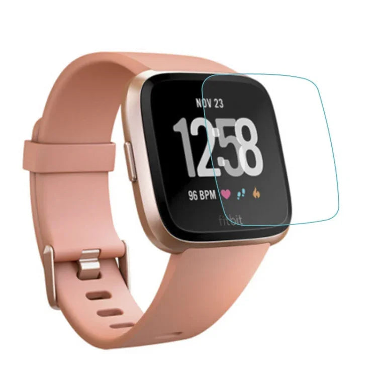 Tempered glass screen protector for smartwatches on Fitbit smartwatch with pink band and digital display.